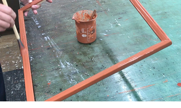 箔（水押し）の下地として膠を溶き入れたアシェットを塗る作業